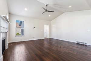 Unfurnished living room with high vaulted ceiling, ceiling fan, and hardwood / wood-style floors