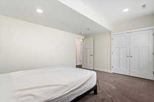 Bedroom with a closet and carpet floors