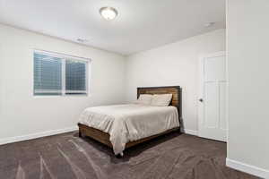 Bedroom featuring dark carpet