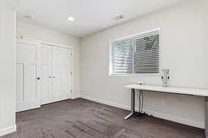 Unfurnished bedroom featuring carpet floors and a closet