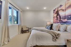 Bedroom with light colored carpet