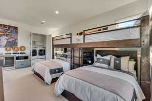 Bedroom with carpet flooring and washing machine and dryer