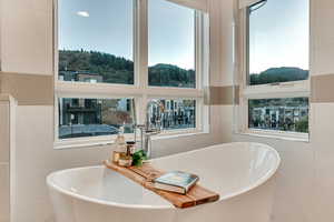 Bathroom featuring tile walls and a healthy amount of sunlight