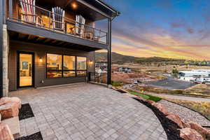 Patio terrace at dusk featuring a balcony