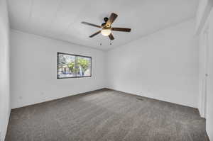 Carpeted empty room with ceiling fan