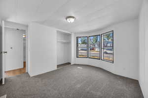 Unfurnished bedroom featuring a closet and hardwood / wood-style floors