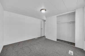 Unfurnished bedroom with a closet and carpet flooring