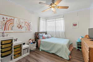 Bedroom featuring ceiling fan and dark wood-type flooring