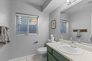 Bathroom with tile patterned floors, toilet, and vanity