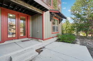 View of exterior entry featuring a patio