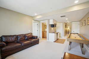 Interior space with light colored carpet and sink