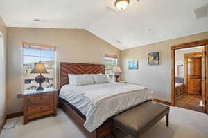 Bedroom with vaulted ceiling and tile patterned floors