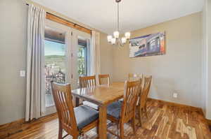 Dining area featuring hardwood / wood-style flooring and an inviting chandelier