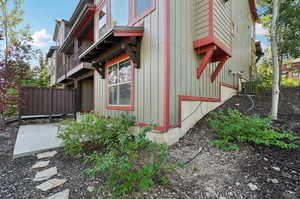 View of side of home featuring central AC