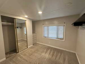 Unfurnished bedroom with carpet and a closet