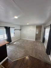 Empty room featuring hardwood / wood-style flooring and plenty of natural light