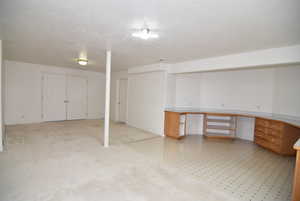 Basement featuring a textured ceiling