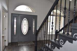 Entrance foyer featuring crown molding and dark hardwood / wood-style floors