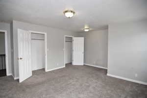 Unfurnished bedroom featuring carpet flooring and a textured ceiling