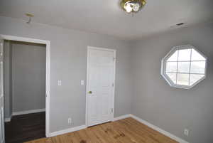 Unfurnished bedroom featuring hardwood / wood-style floors