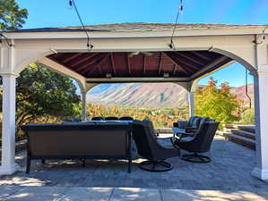 View of patio / terrace with a gazebo, a mountain view, and an outdoor living space