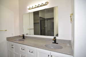 Bathroom featuring vanity and an enclosed shower