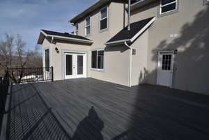 Wooden terrace featuring french doors