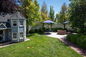 View of yard with a patio and an outdoor structure