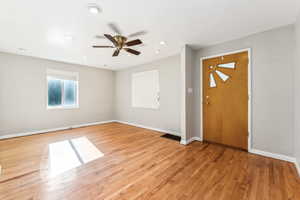 Entryway with ceiling fan and light wood-type flooring