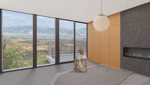 Unfurnished bedroom with a mountain view and a tiled fireplace