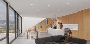 Living room featuring wood walls, a mountain view, and expansive windows