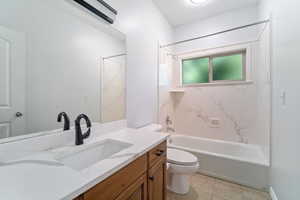 Full bathroom featuring tile patterned floors,  shower combination, vanity, and toilet