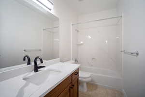 Full bathroom featuring tile patterned floors, shower / bathtub combination, vanity, and toilet