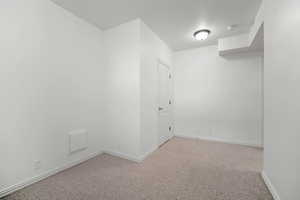 Empty room with light colored carpet