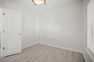 Unfurnished room with light wood-type flooring