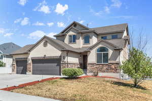 View of front facade featuring a garage and a front yard