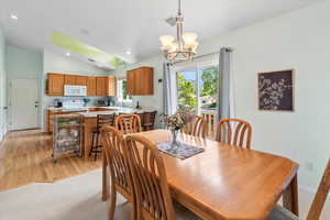 Dining area featuring sink,  light carpet, and lofted ceiling