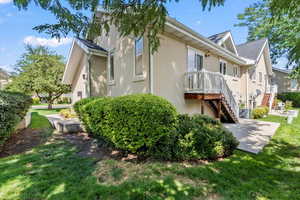 View of side of property featuring a lawn