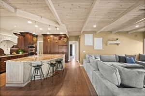 Living room featuring sink, beam ceiling, and dark hardwood / wood-style floors