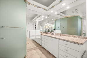 Bathroom featuring tile patterned flooring and vanity