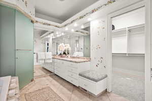 Bathroom with dual vanity, a shower with door, and tile patterned floors