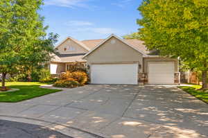 View of front of property with an EXTRA TALL 3RD GARAGE  garage and a front lawn