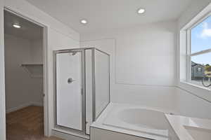 Bathroom featuring vanity, independent shower and bath, and a textured ceiling