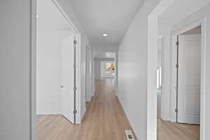 Corridor featuring light hardwood / wood-style flooring