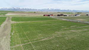 Surrounding community with a rural view, a lawn, and a mountain view