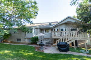 Rear view of property featuring a patio and a yard