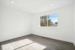 Empty room with hardwood / wood-style flooring