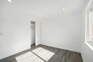 Unfurnished bedroom featuring a closet and hardwood / wood-style floors