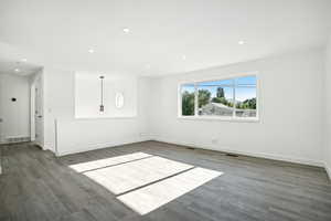 Spare room with dark wood-type flooring