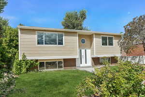 Split foyer home with a front yard